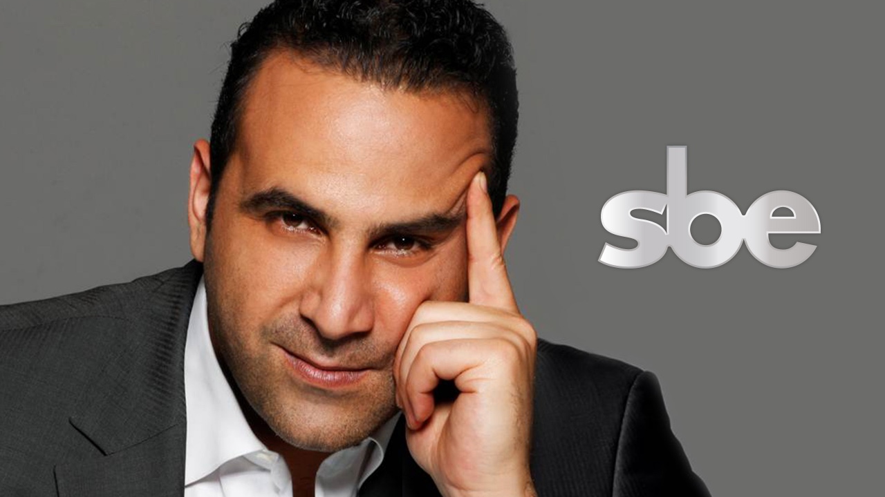 A man in a suit is posing for brand development.