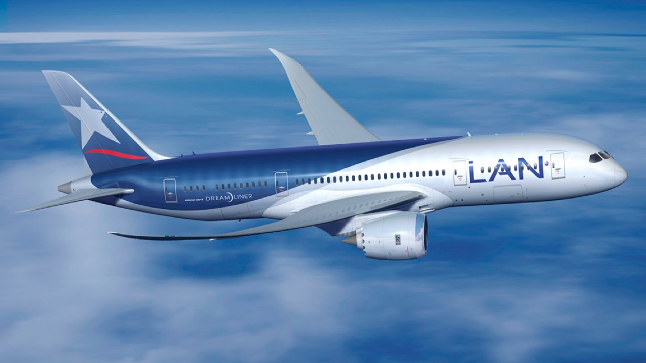 A blue and white airplane flying in the sky.