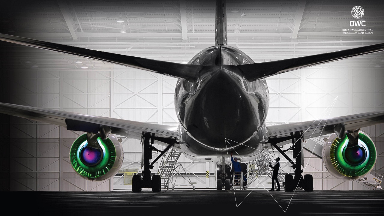 A large jet airplane is sitting in a hangar as part of an integrated marketing campaign featuring air travel.