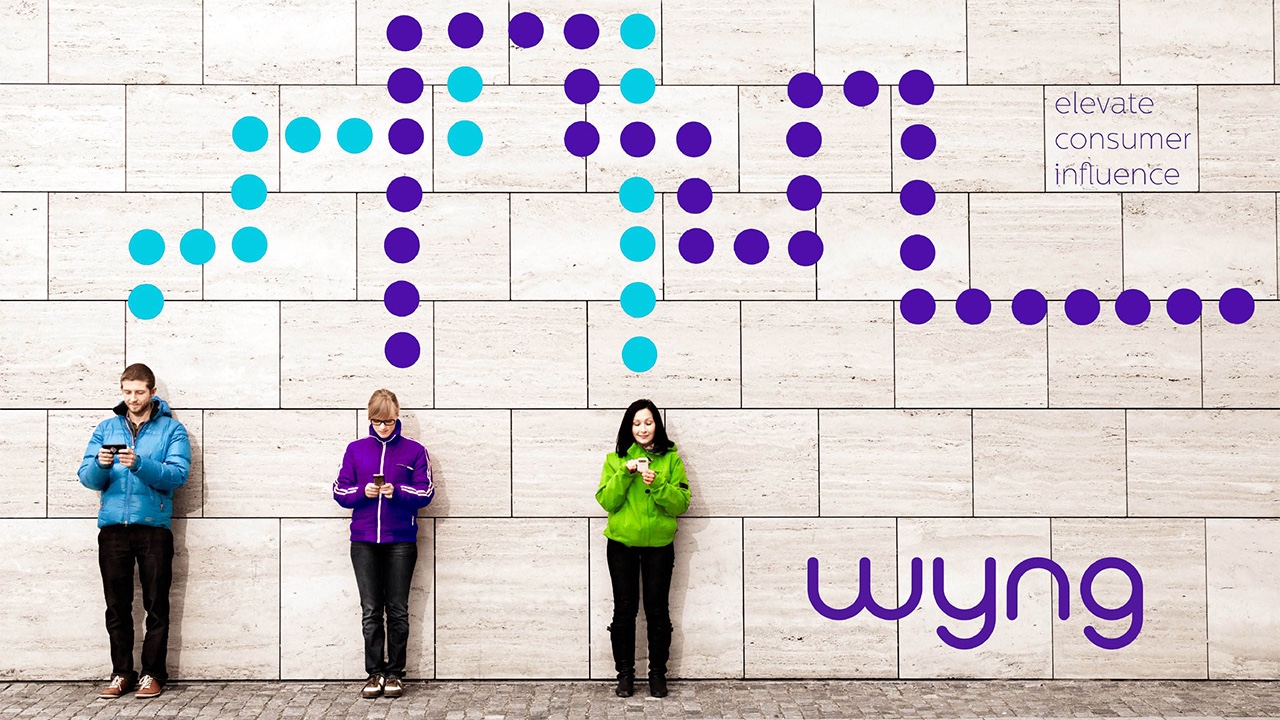 A group of people standing in front of a wall showcasing the brand strategy.