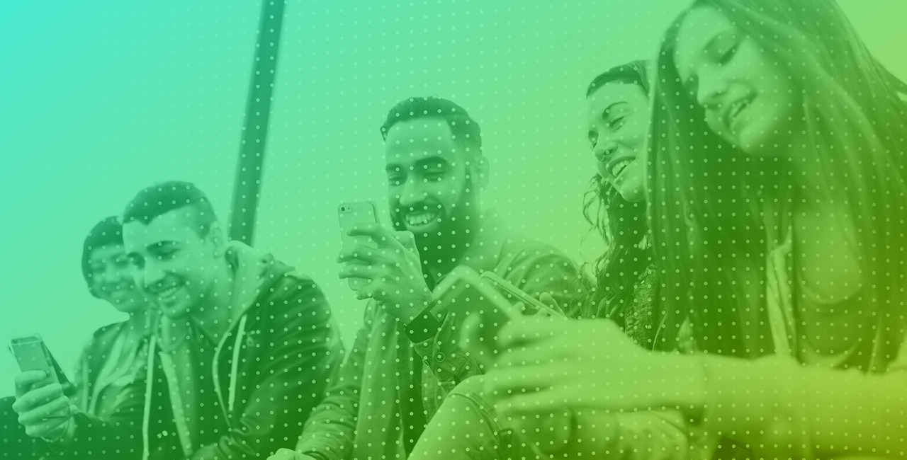 A group of people looking at their phones.