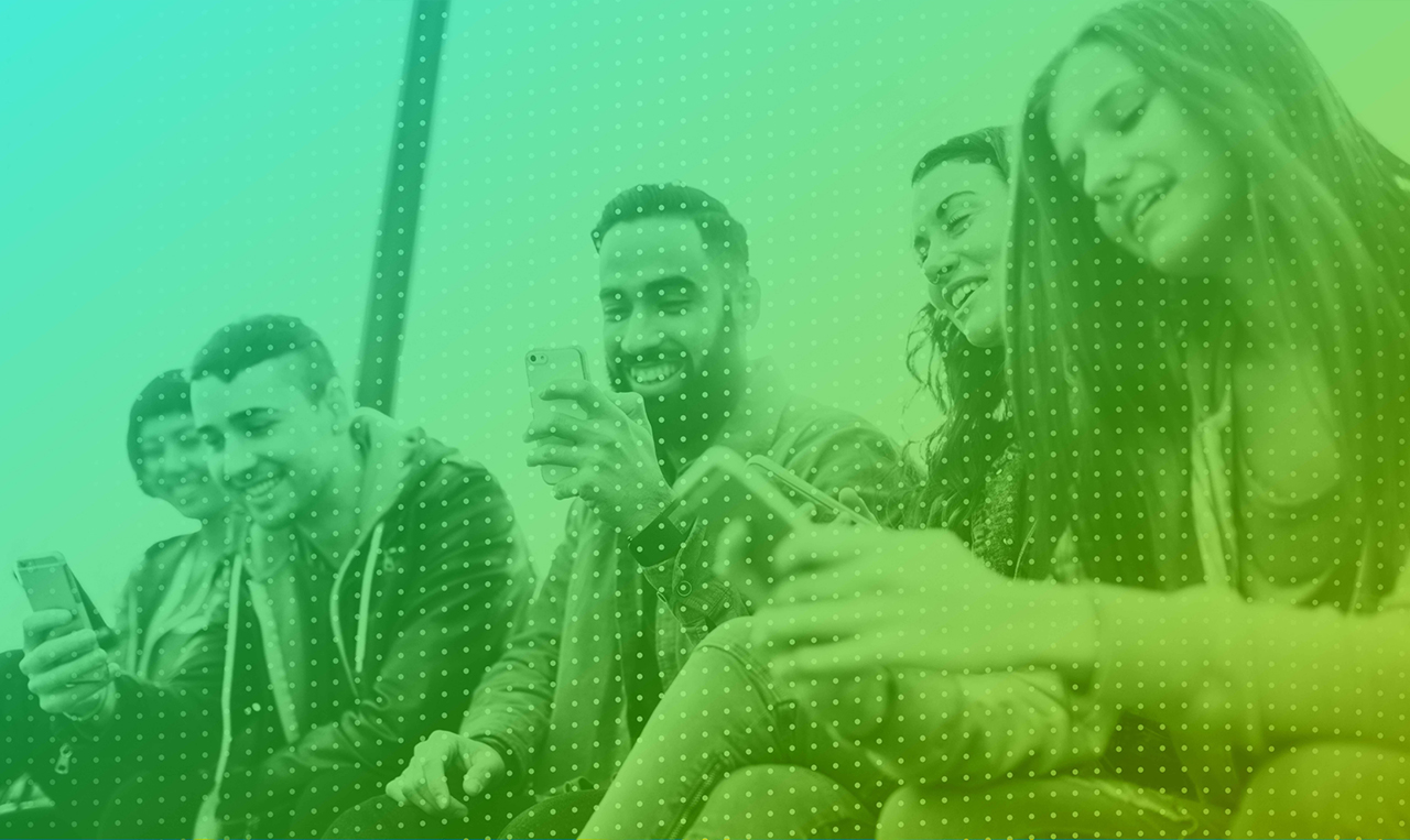 A group of people looking at their phones.