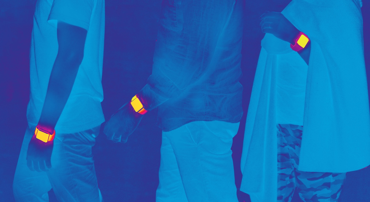 A group of people standing in front of a blue background.