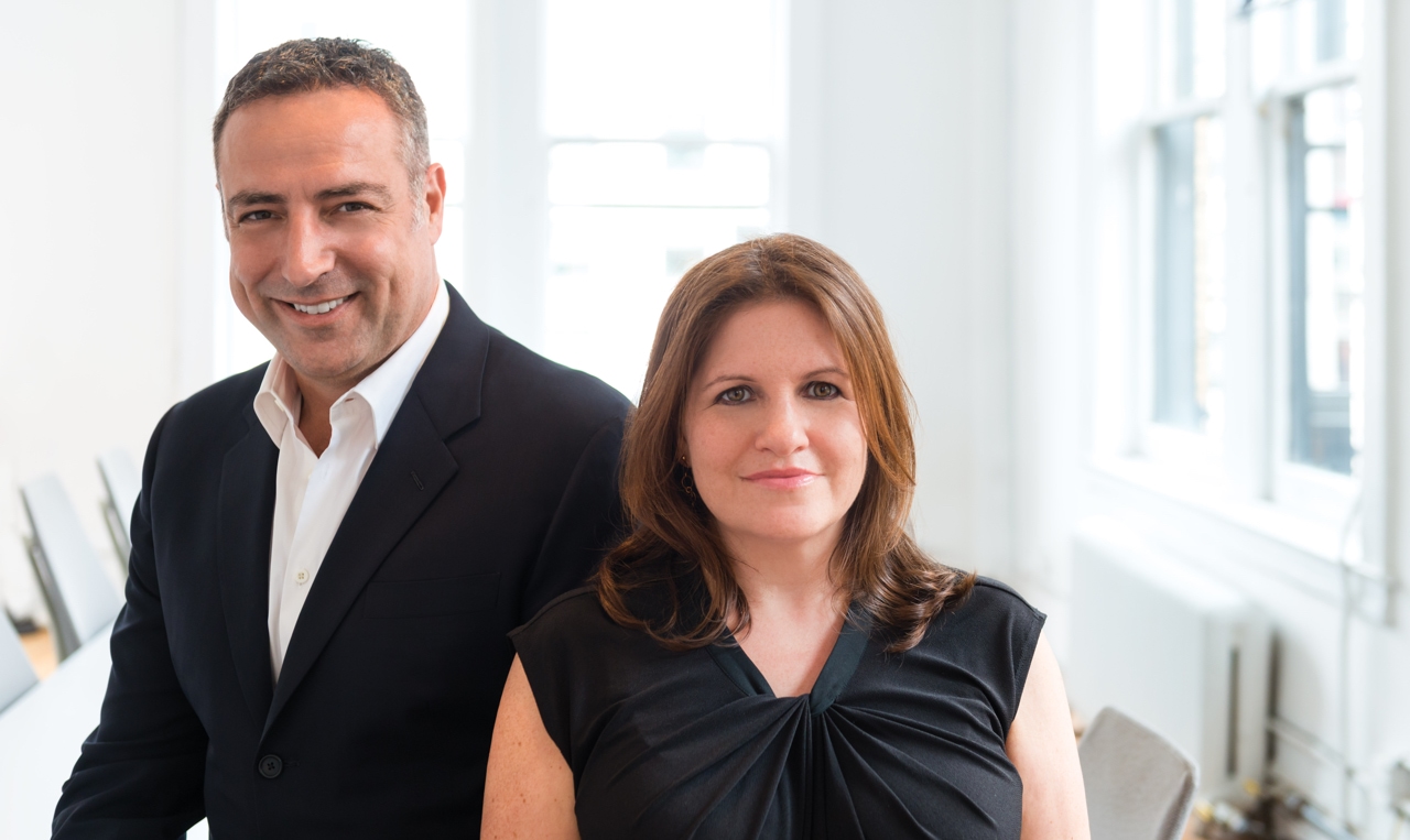 Mario Natarelli and Rina Plapler posing for a photo in an office.