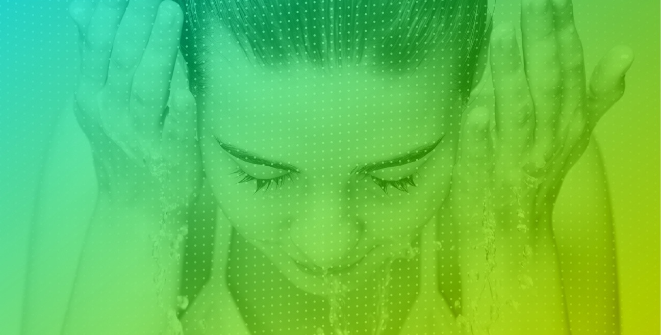 A woman cleaning her face with a green gradient tint overlay
