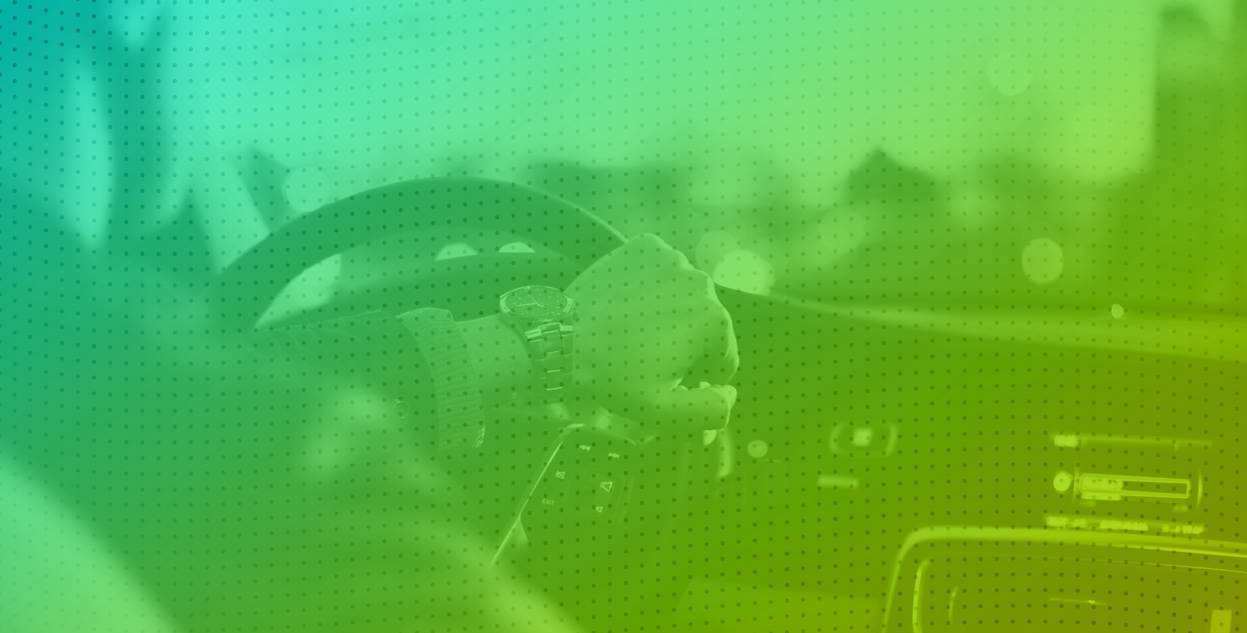 A person driving a car with a green background.