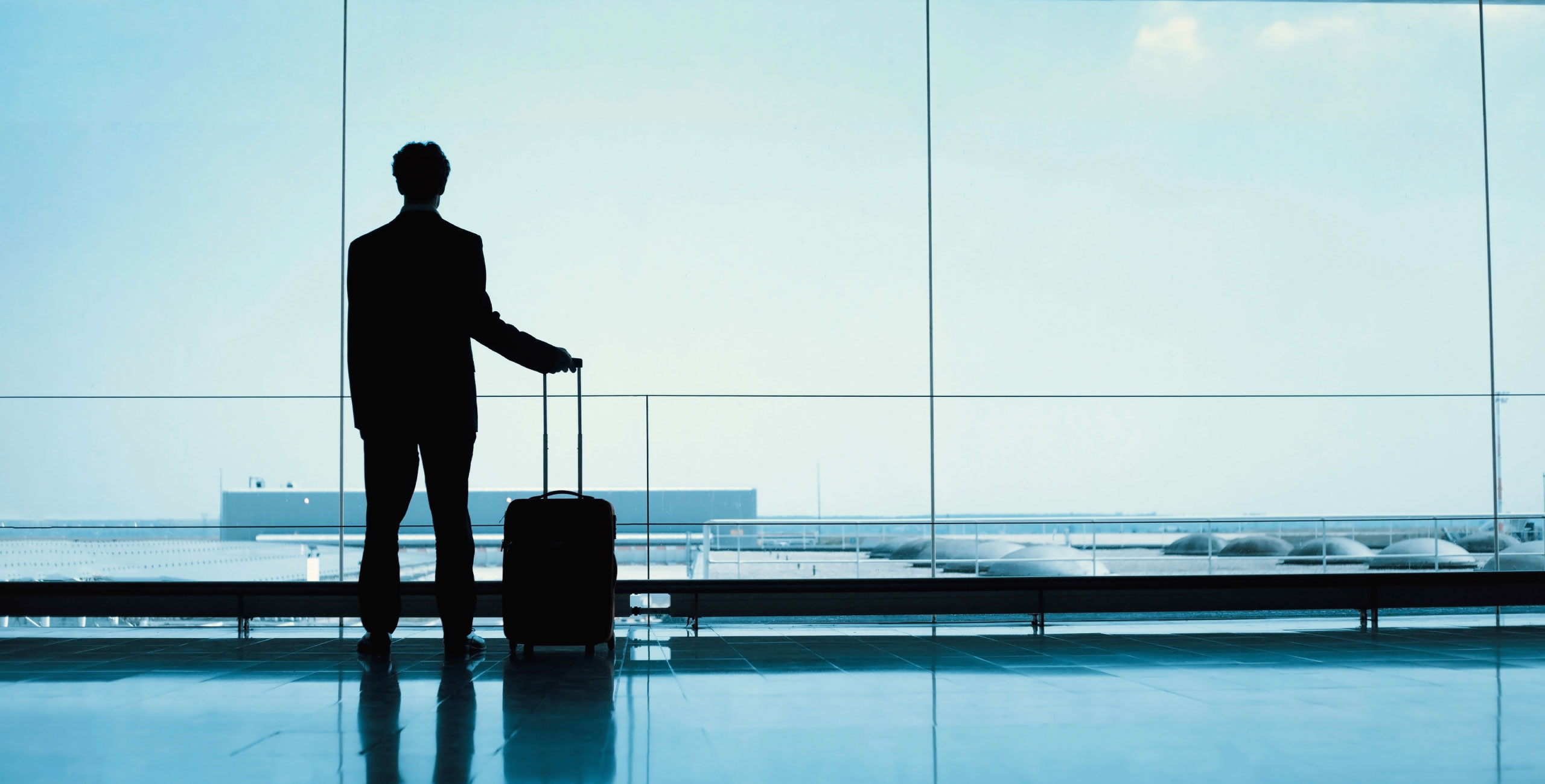 A silhouette of a man with a suitcase.