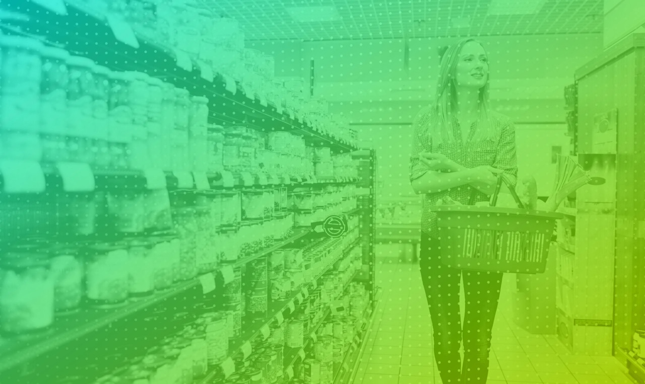 A woman is standing in a grocery store aisle.
