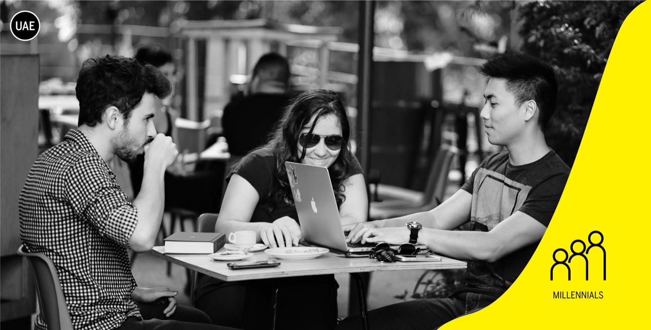A group of people sitting at a table using laptops