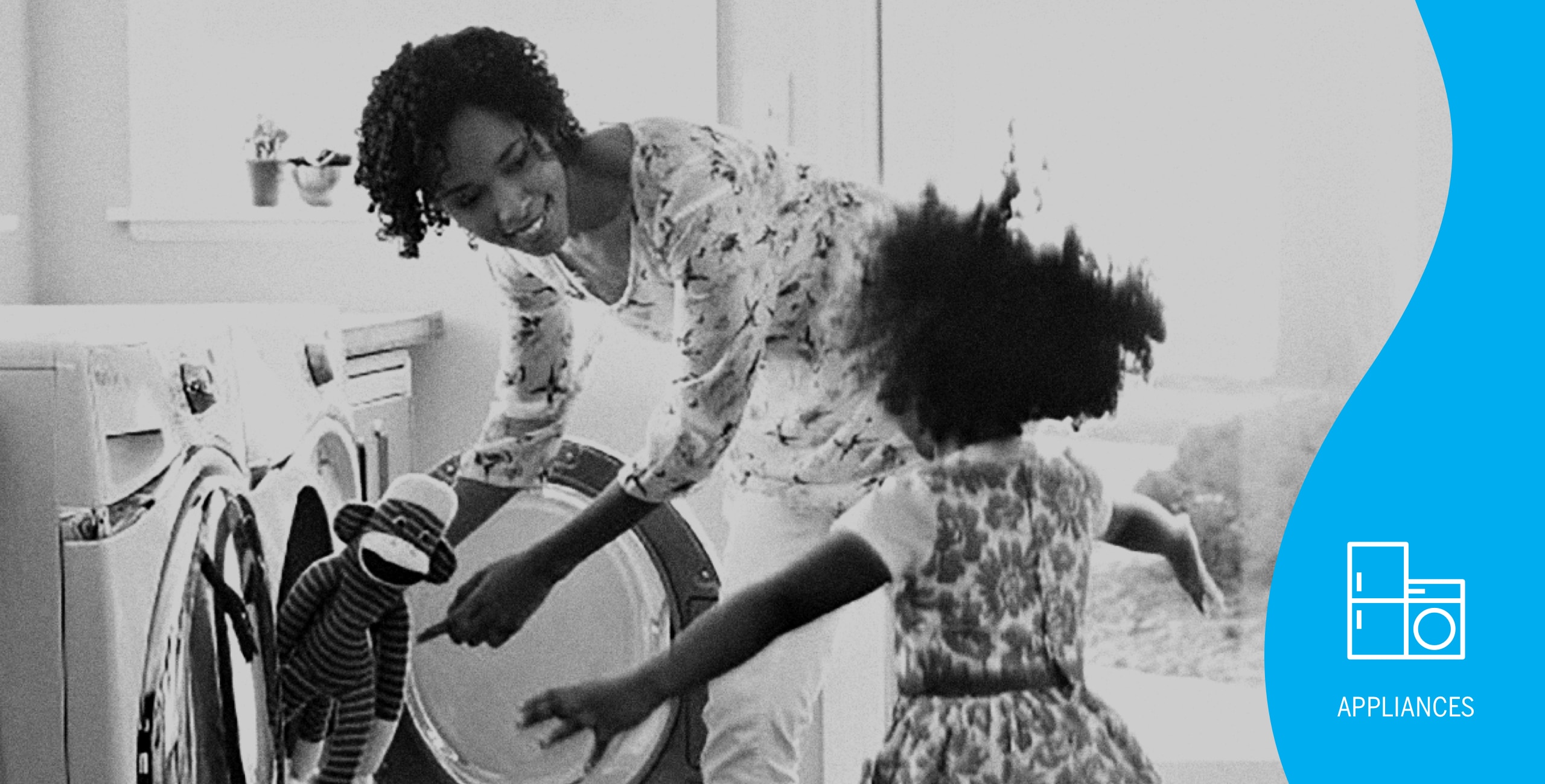 appliances-hero-image showing woman taking stuffed toy out of washing machine and child excited