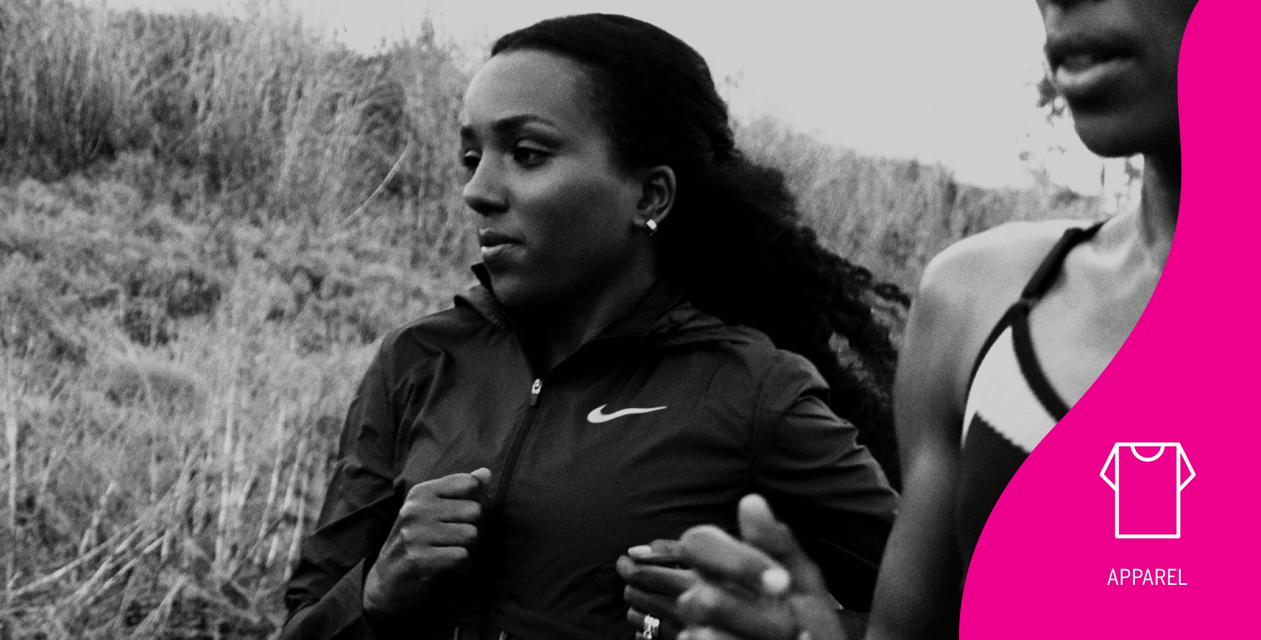 Two women are running in a field.