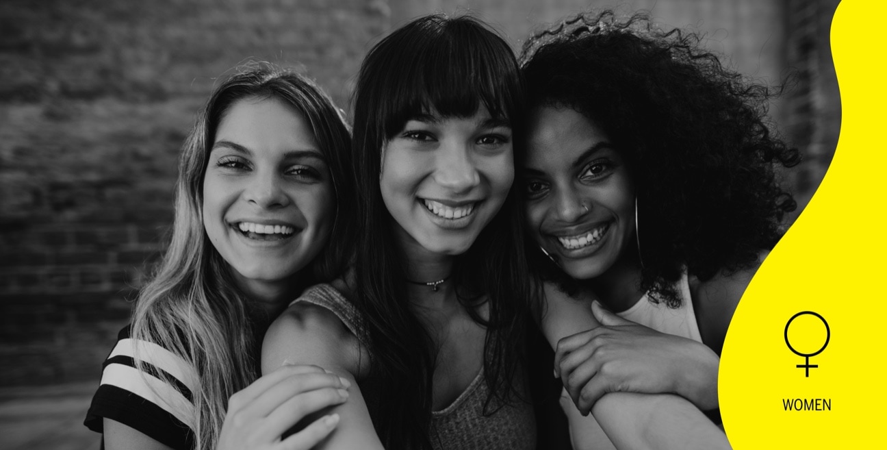 Black and white image of 3 young women smiling, looking at the camera, with a woman icon on a yellow shape on the right.