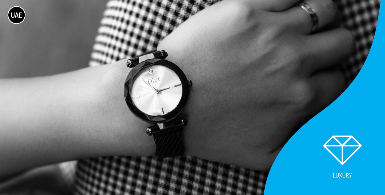 A woman's wrist with a watch on it.