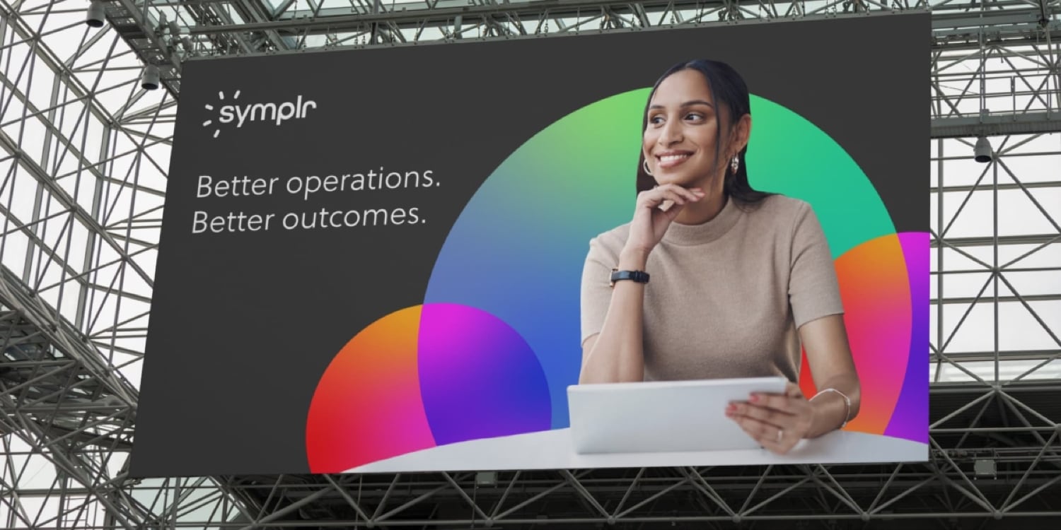 A large billboard with a woman holding a tablet.