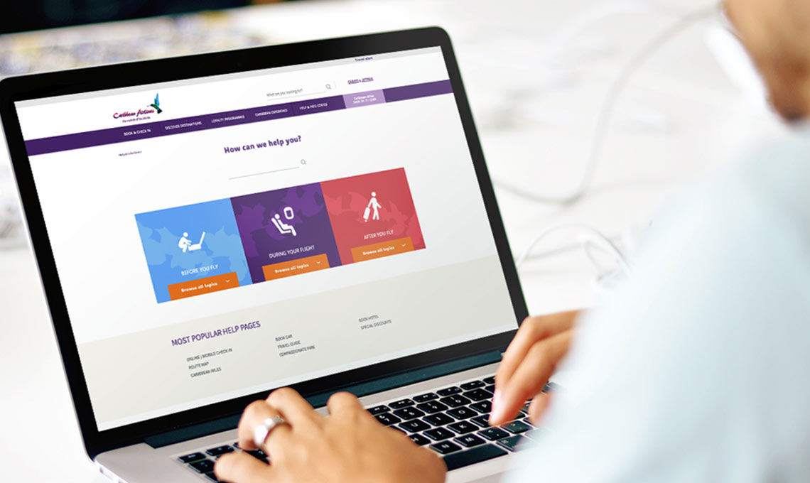 A woman is using a laptop for a website redesign.