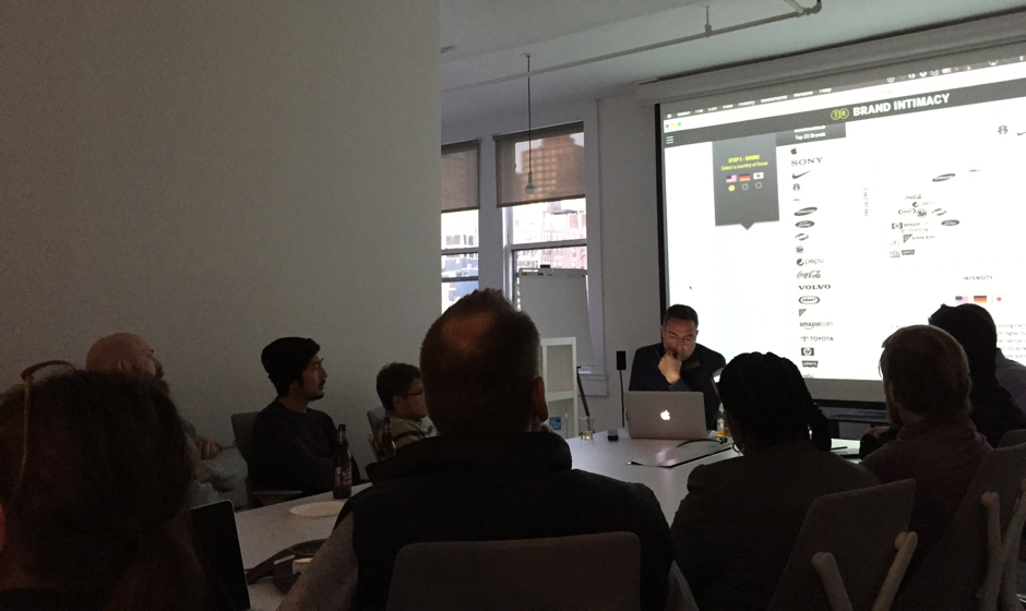 A matrix of people sitting around a table in a conference room.