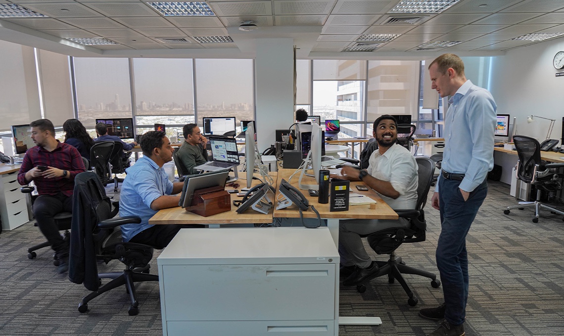 A group of people sitting at desks in an office.