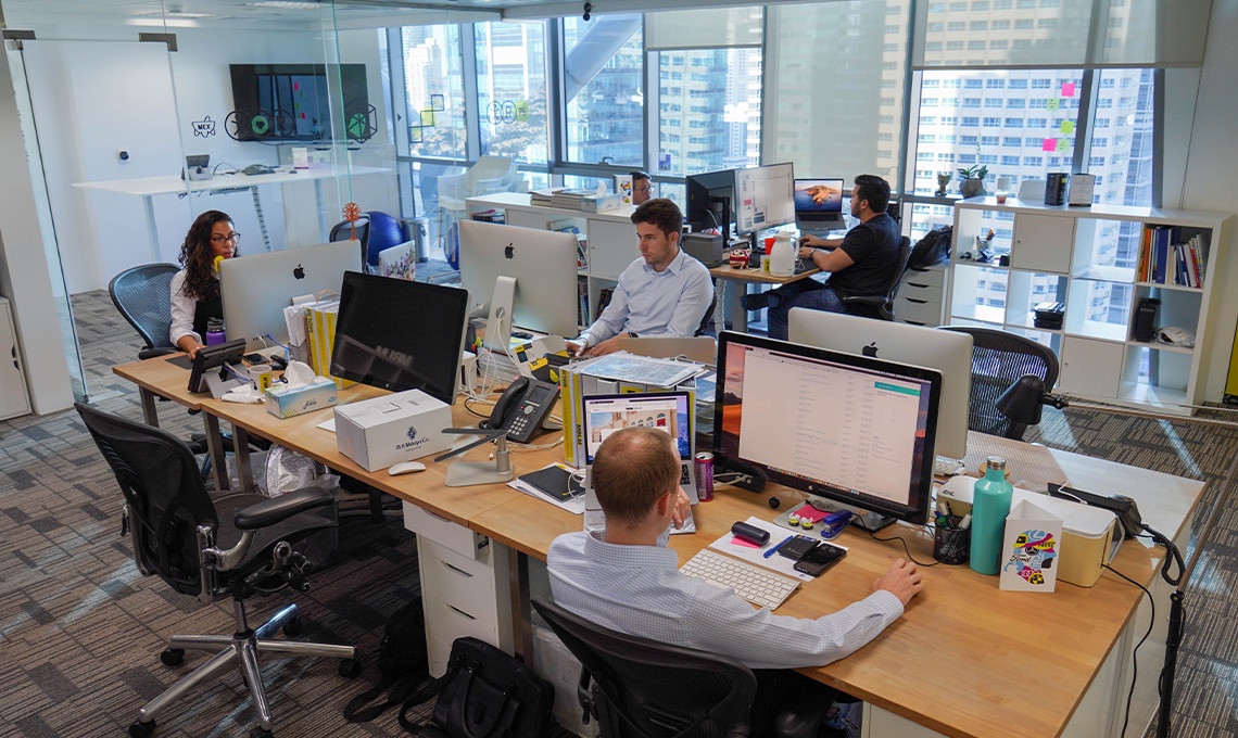 A group of people working at desks in an office.