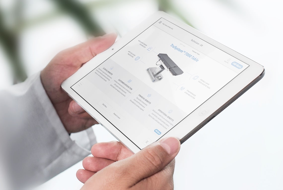 a man with a tablet in his hands with a presentation developed with PresentationOS for Hillrom