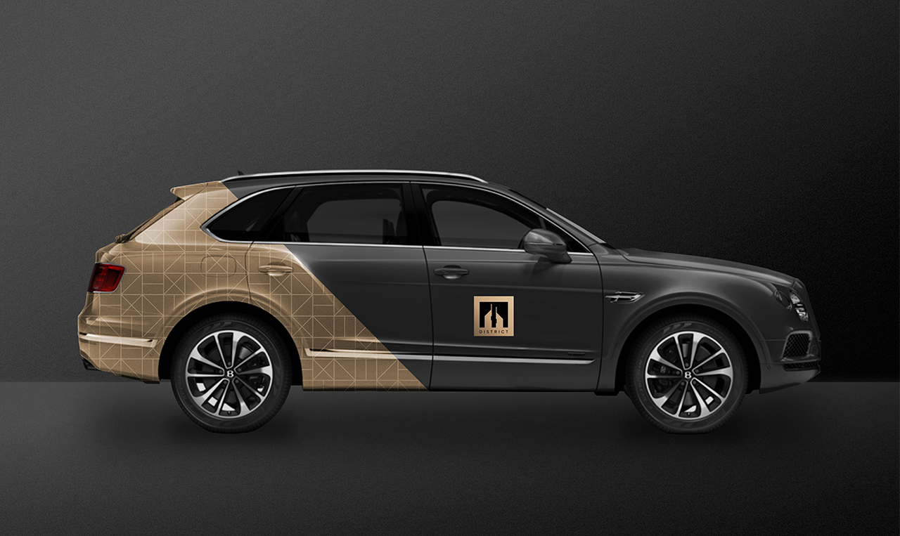 examples of the design system developed for Emirates Towers District applied to the side of a black SUV