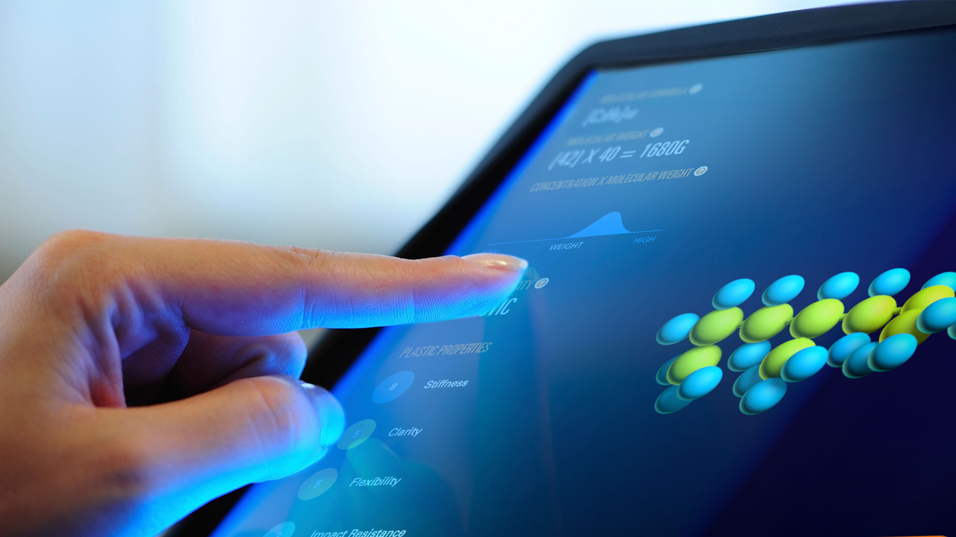 A person points to a computer screen showing part of the multimedia designs developed for Borouge.