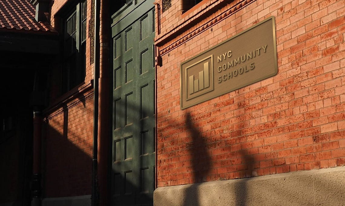 A red brick building with a sign on it.