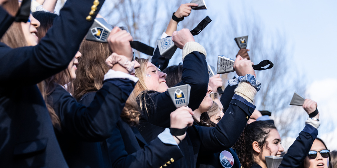 A group of people in suits are holding up their phones, showcasing a revitalized identity.