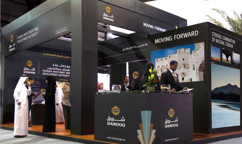 A trade show booth showcasing products with people in attendance.