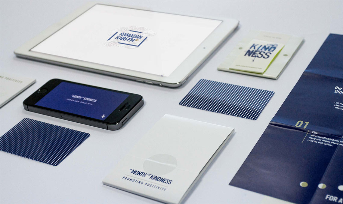 A business card with a Ramadan greeting is among the items on a table.