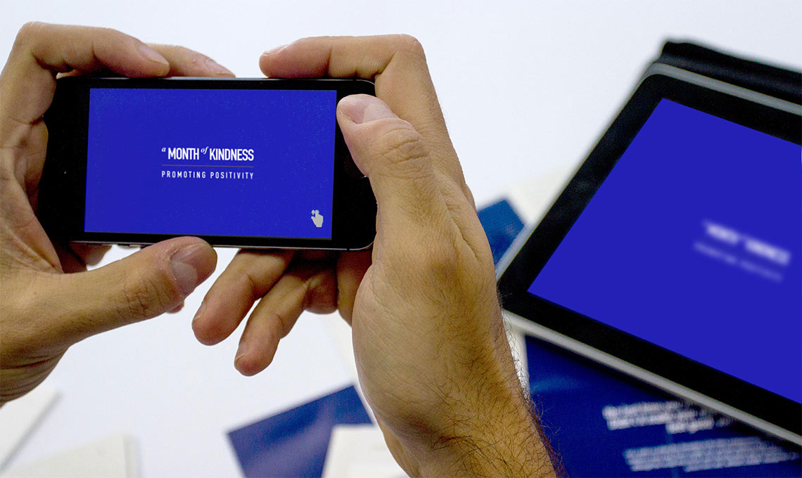 A person is taking a picture of a blue screen on a cell phone while capturing a Ramadan greeting.