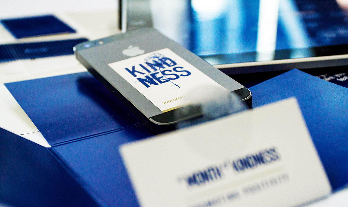 A cell phone is sitting on a table next to a Ramadan greeting business card.