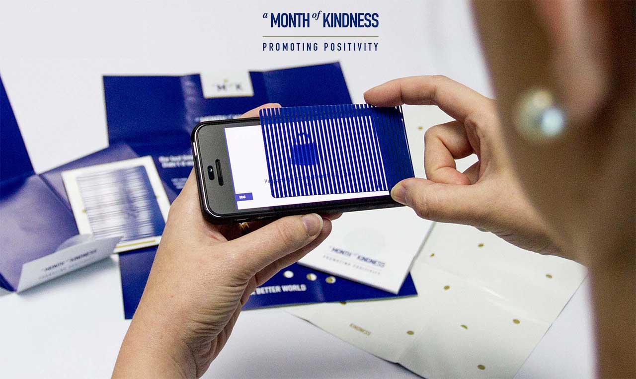 A person taking a picture of a Ramadan greeting displayed on a cell phone.