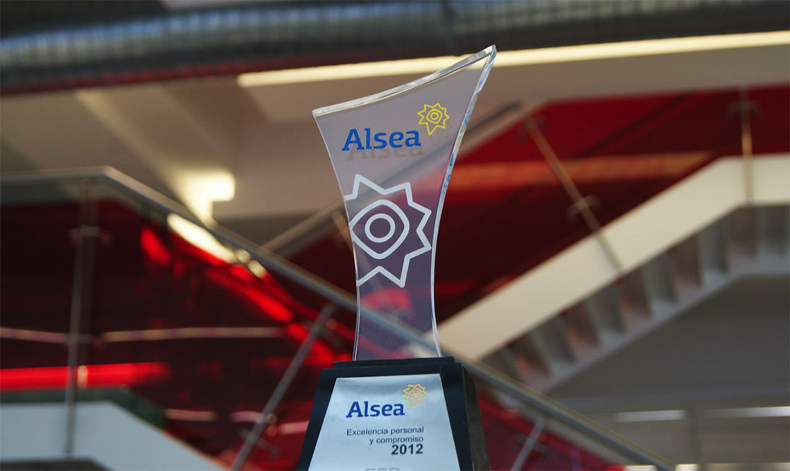 A trophy representing brand repositioning sits on top of a staircase.