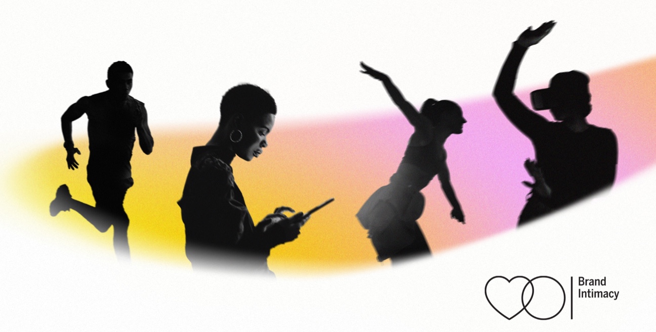 A group of people are silhouetted in front of a colorful background.