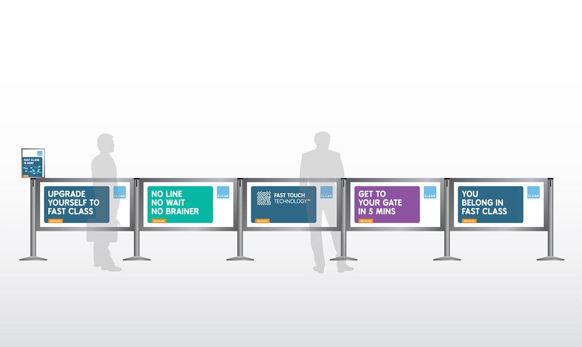 A group of people raising brand awareness in front of a line of signs.