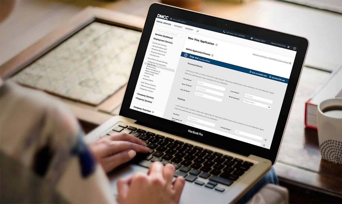 A woman is using a laptop computer to fill out a form on an integrated portal.