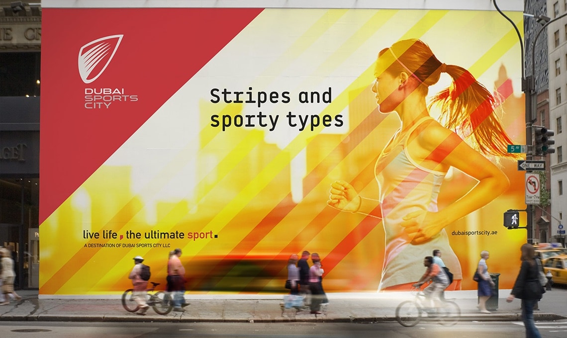 A woman is sprinting down the street in front of a billboard showcasing a rebranding program.