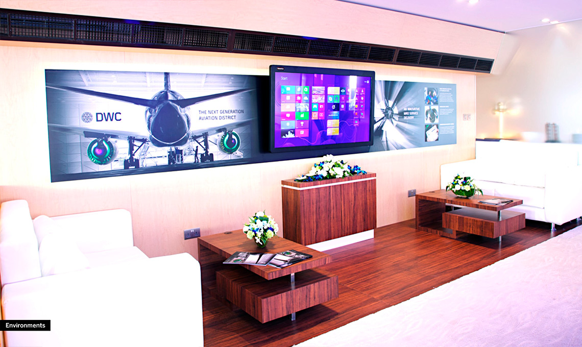 A living room with an integrated TV on the wall.