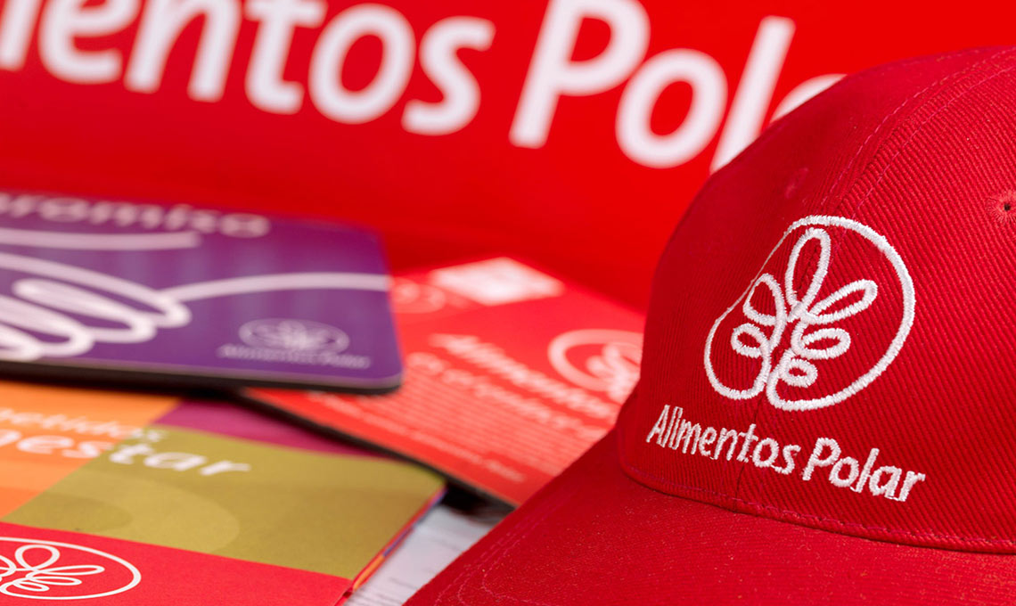 A red hat with a logo on it sits on a table.