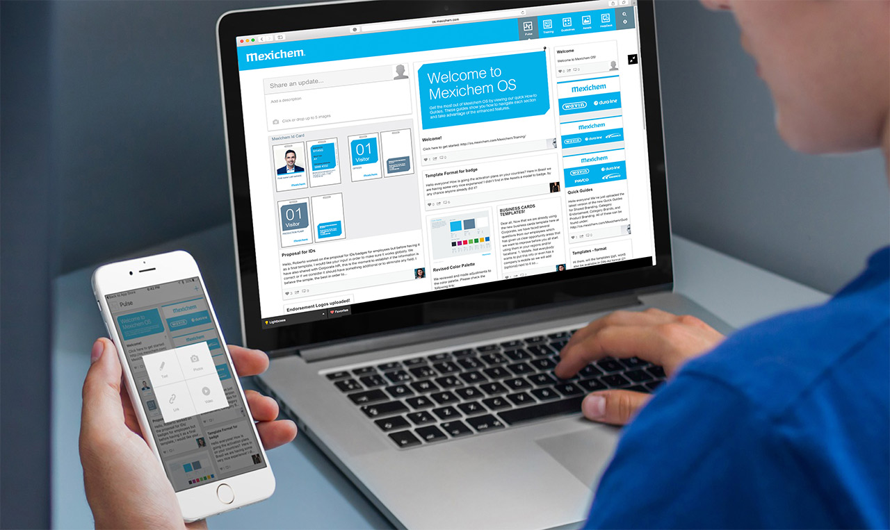 A person on a laptop with a cellphone.