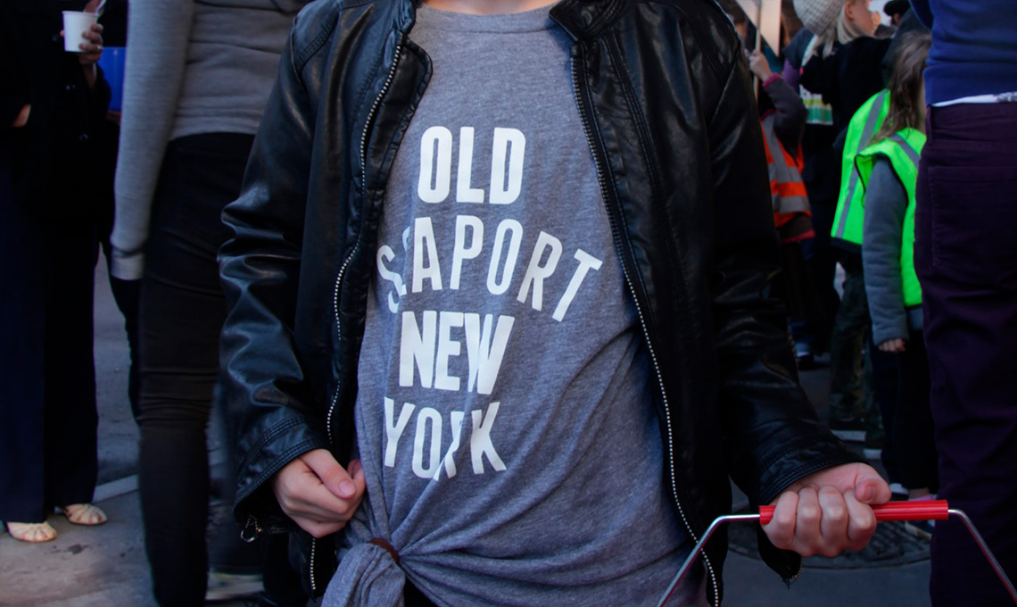 A girl wearing a t-shirt that says Old Seaport UK.