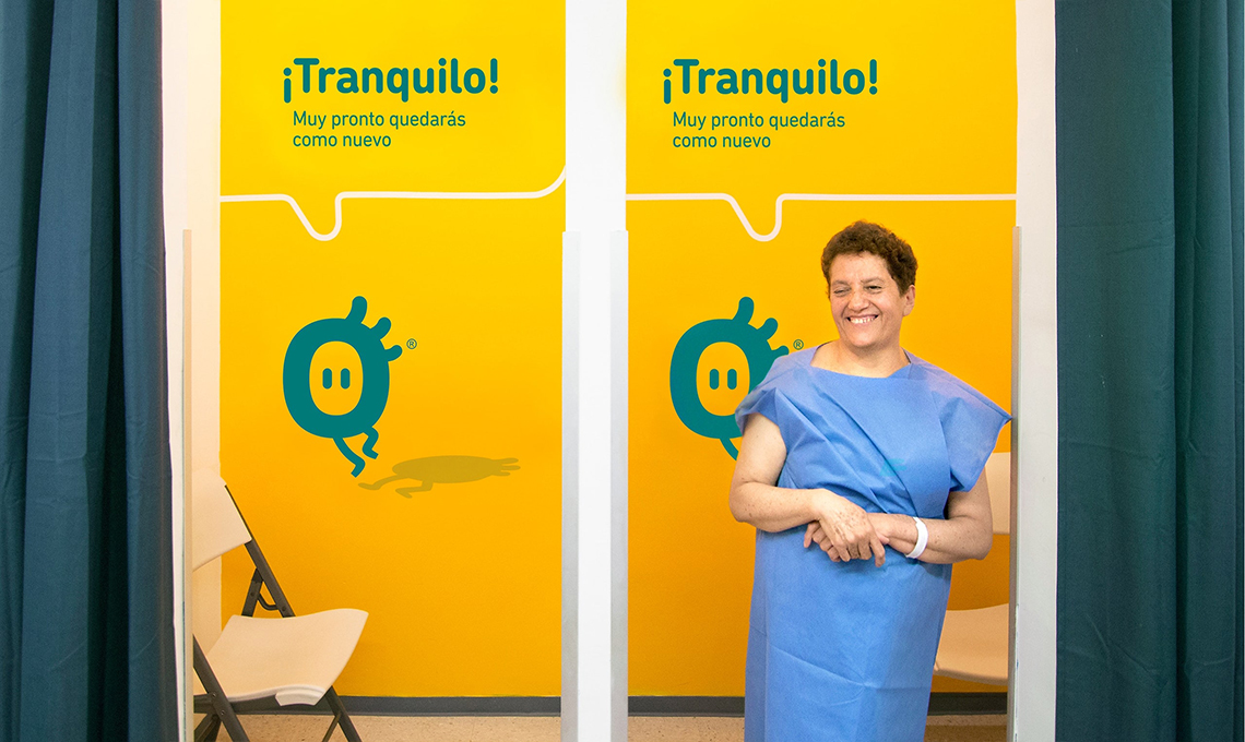 A woman redefining the experience of standing in front of a door with a sign on it.