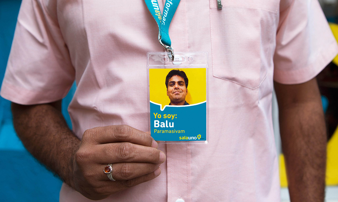 A man redefining the experience of seeing, holding an id card.