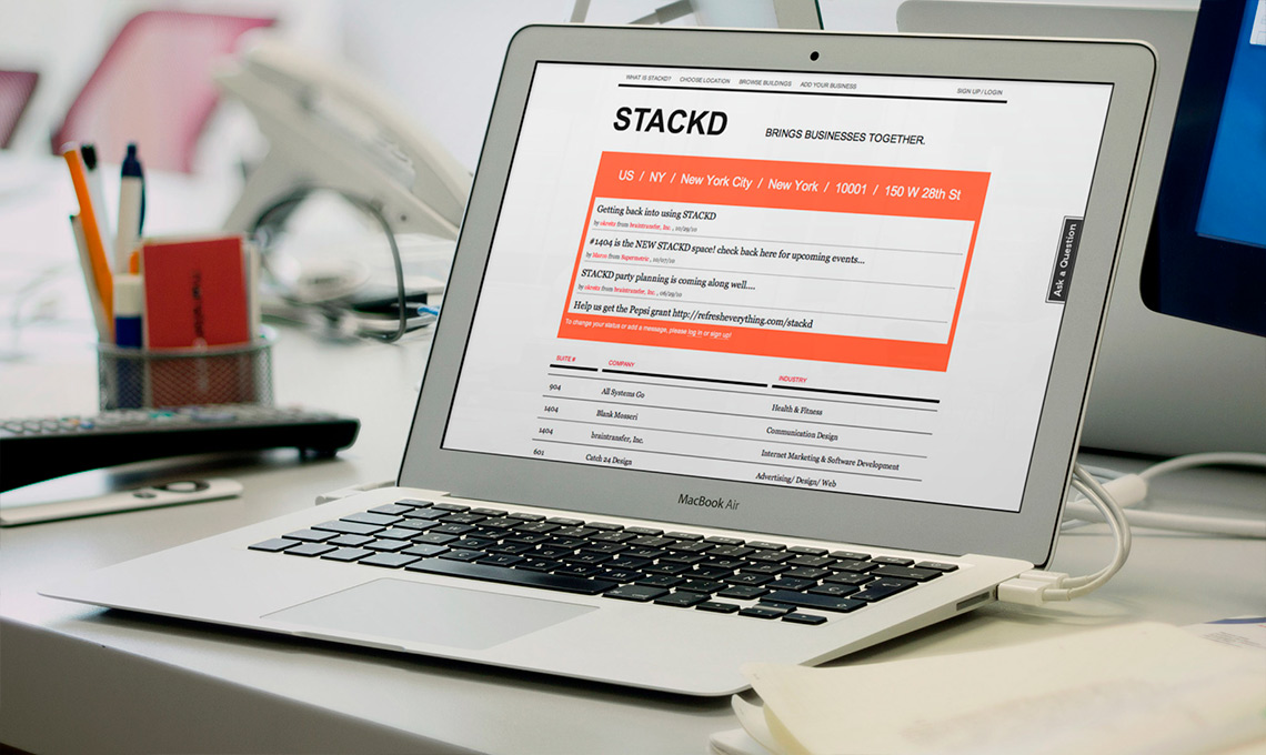 A stack of laptop computers is on a desk.