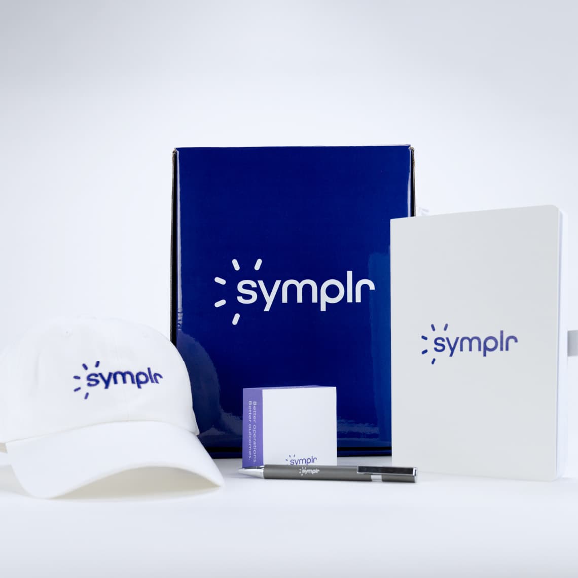 Examples of the design system applied to Marketing materials including swag items like baseball caps, pens, and notepads