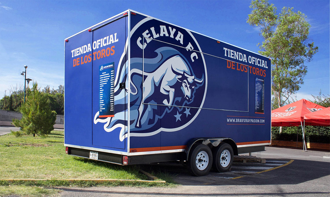 A new blue and white truck parked in a parking lot.