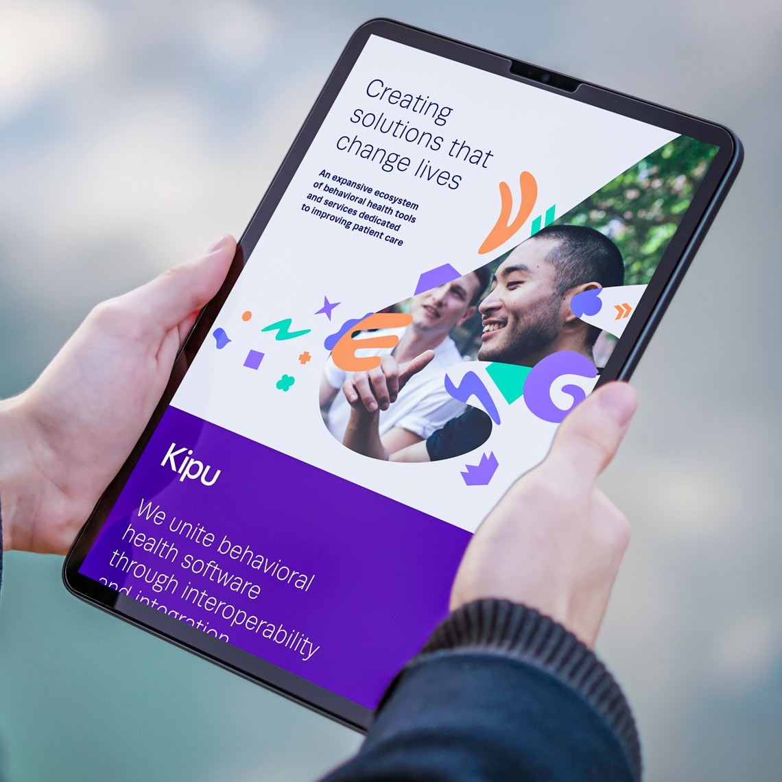 A man with a tablet in his hands with the website designed for Kipu