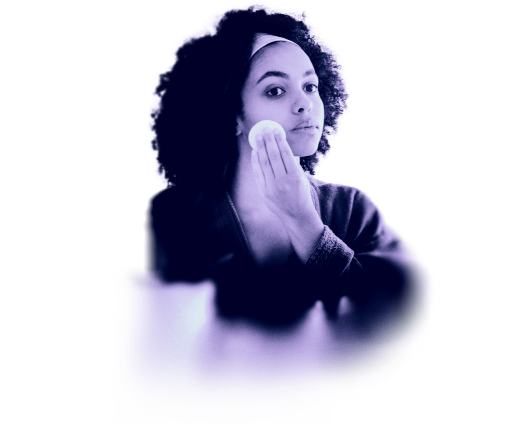 a young woman cleaning her face