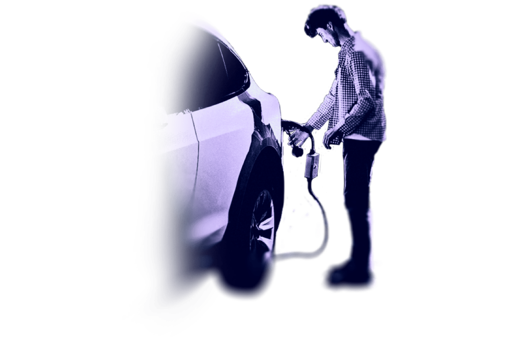 a man charging his electric vehicle