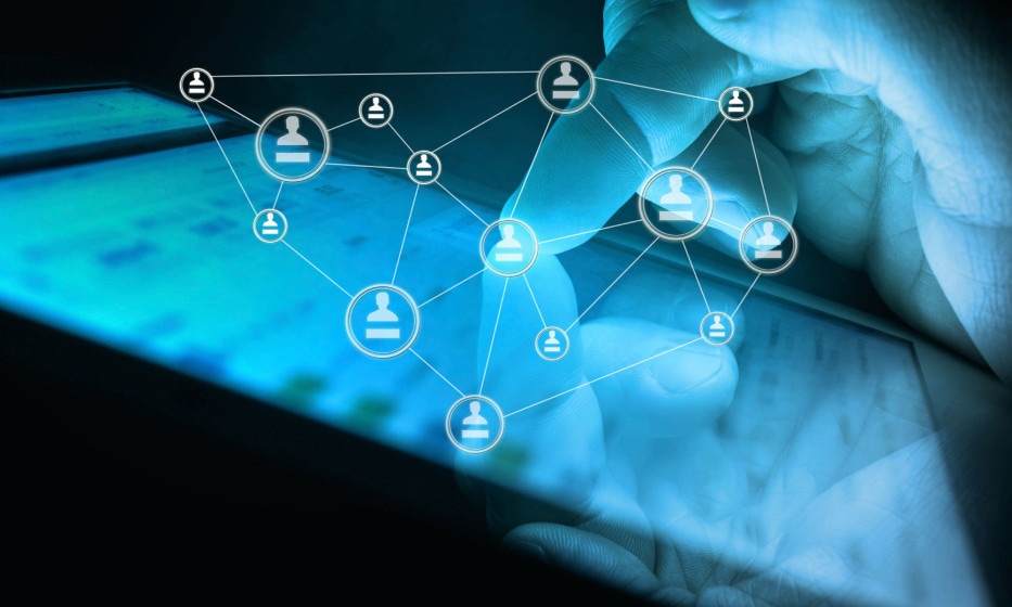 Finger touching tablet with overlay showing connections between people